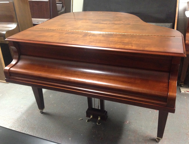 Mahogany baby grand piano.