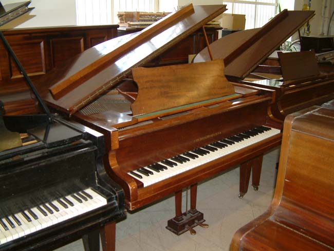 Fiddleback mahogany baby grand piano