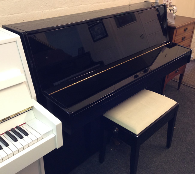 Opus small black upright piano. 