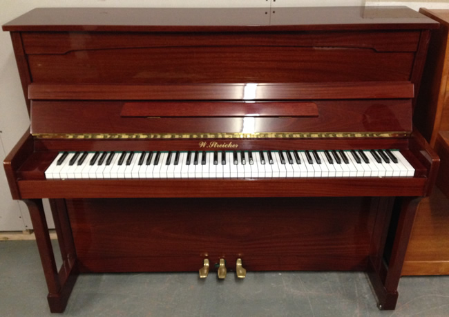 Streicher upright piano in a Mahogany high gloss finish.